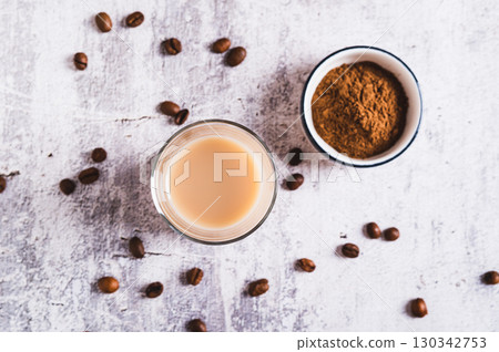 Close up of Yemeni coffee with cardamom, cinnamon and cream in a glass on table top view 130342753
