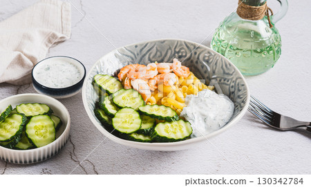 Bowl with pasta, shrimp, cucumber and sauce on the table web banner Bowl with pasta, shrimp, cucumber and sauce on the table web banner 130342784