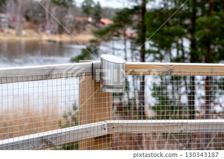 Modern stainless steel solar lamp mounted on fence 130343187