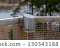 Modern stainless steel solar lamp mounted on fence 130343188