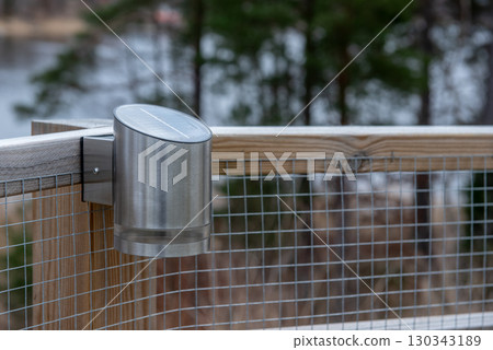 Modern stainless steel solar lamp mounted on fence Modern stainless steel solar lamp mounted on fence 130343189
