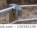 Modern stainless steel solar lamp mounted on fence 130343190