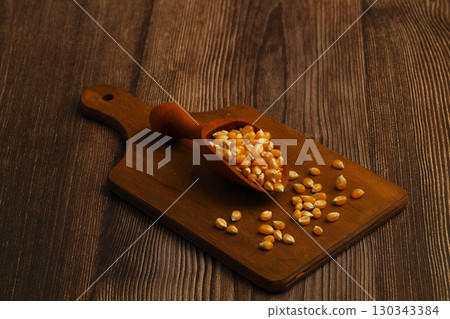 Corn seeds for popcorn isolated on dark rustic background. Copy space 130343384