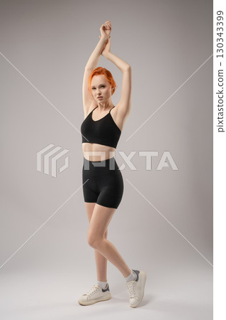 Woman expressing beauty in a nude, artistic light projection setting 130343399