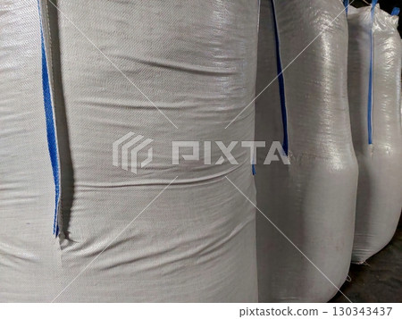 Heavy Bags Filled With Raw Materials in Industrial Warehouse Storage Area in Daytime Heavy Bags Filled With Raw Materials in Industrial Warehouse Storage Area in Daytime 130343437
