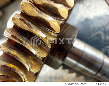Close-up View of a Bronze Worm Gear Wheel Showcasing Intricate Details and Craftsmanship Close-up View of a Bronze Worm Gear Wheel Showcasing Intricate Details and Craftsmanship 130343447
