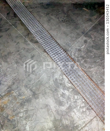 Sewer Grate Set Into the Floor With a Textured Surface and Surrounding Concrete Sewer Grate Set Into the Floor With a Textured Surface and Surrounding Concrete 130343452
