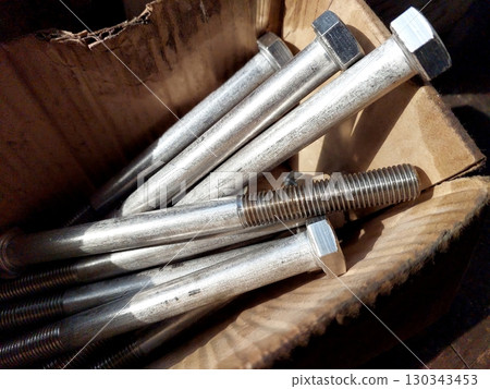 Box Containing Steel Bolts Ready for Use in Construction and Engineering Projects 130343453