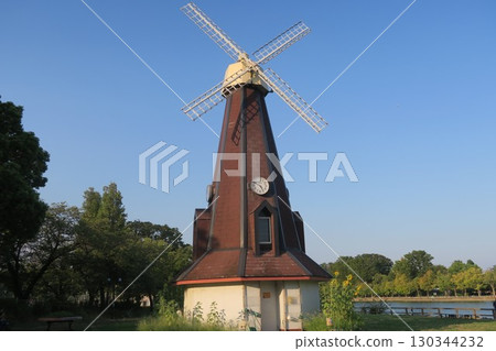Landscape with windmill and sunflowers Landscape with windmill and sunflowers 130344232