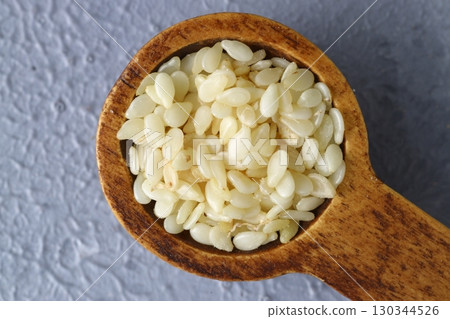 close up of sesame flour and sesame seeds in a wooden spoon. alternative type of flour. gluten free product. flour for dieting and low carb healthy meal 130344526