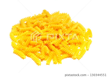 pile of spiral pasta scattered on light background. corkscrew shaped spiral pasta or fusilli pasta on white background 130344551