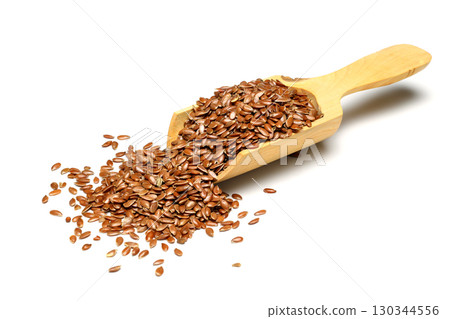 Vegetarian organic nutrition flax seeds in scoop on white background Vegetarian organic nutrition flax seeds in scoop on white background 130344556