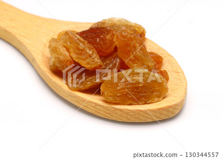 Brown raisins in wooden spoon isolated on white background with clipping path. Top view. Flat lay Brown raisins in wooden spoon isolated on white background with clipping path. Top view. Flat lay 130344557