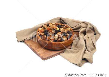 Mix of nuts and dried fruits in wooden bowl isolated on a white background. 130344832