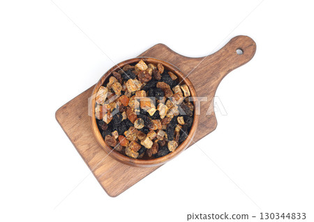 Mix of nuts and dried fruits in wooden bowl isolated on a white background. 130344833