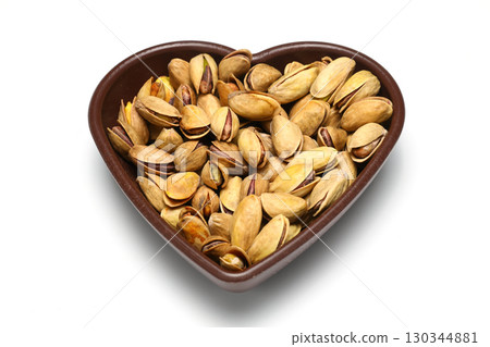 Heap pistachios isolated on white background, close up. 130344881