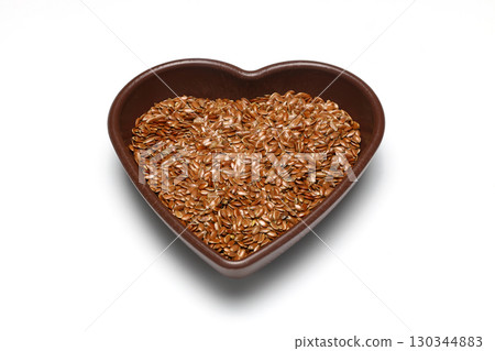 Pile of flax seeds isolated on white background 130344883