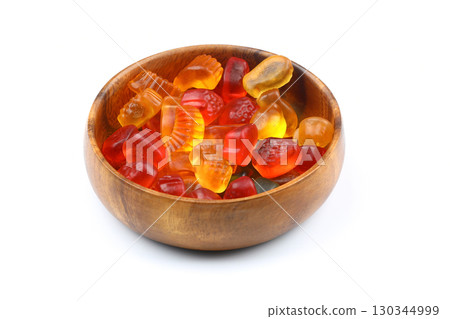 Colorful Jelly in a wooden bowl. isolated on white background Colorful Jelly in a wooden bowl. isolated on white background 130344999