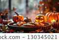 Halloween theme decorative composition with cookies on plate and smiling pumpkins 130345021