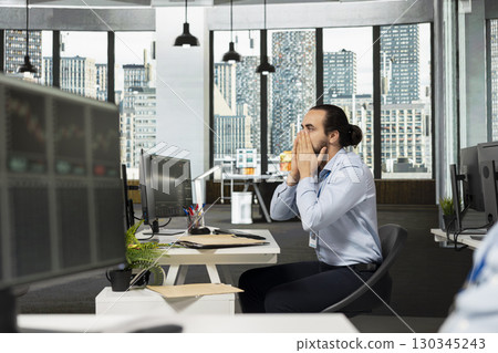 Prop firm trader gasping after seeing news of recession affecting stock market valuations, worried about losing money. Man covering mouth in shock, disturbed by Black Swan event upset causing chaos Prop firm trader gasping after seeing news of recession affecting stock market valuations, worried about losing money. Man covering mouth in shock, disturbed by Black Swan event upset causing chaos 130345243