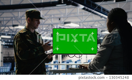Server room army experts deploy AI tech on green screen PC to modernize defense. Military server room colleagues using chroma key computer to integrate artificial intelligence technology, camera B 130345248
