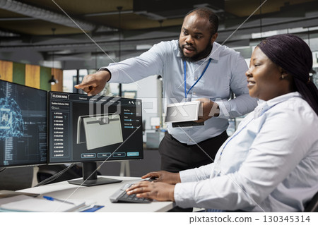 Researchers in office using artificial intelligence to build solar powered prototype to meet sustainability goals. Colleagues use AI deep learning to prototype solar cells gadget with lower costs Researchers in office using artificial intelligence to build solar powered prototype to meet sustainability goals. Colleagues use AI deep learning to prototype solar cells gadget with lower costs 130345314