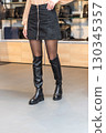 girl in black skirt and black shoes 130345357