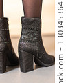 women's black shoes on a gray sofa 130345364