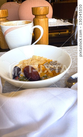 Bowl of cereals with almonds, dates, and pumpkin seeds creating nutritious breakfast in restaurant setting, accompanied by cappuccino , breakfast radiating wholesome energy. Bowl of cereals with almonds, dates, and pumpkin seeds creating nutritious breakfast in restaurant setting, accompanied by cappuccino , breakfast radiating wholesome energy. 130345850