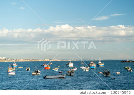 Colorful Fishing Boats Bobbing on a Serene Ocean Colorful Fishing Boats Bobbing on a Serene Ocean 130345945