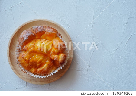 Orange mango sweet bread. Freshly baked sweets served on a wooden plate. Orange mango sweet bread. Freshly baked sweets served on a wooden plate. 130346262