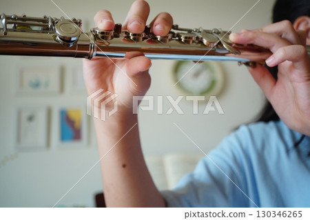 Hands of a child playing the flute. Wind band and classical music instrument performances. 130346265