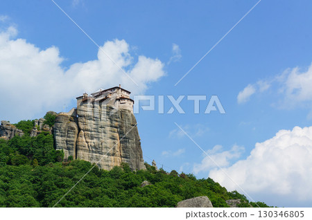 A view of the towering rock formations of Meteora under a blue sky 130346805