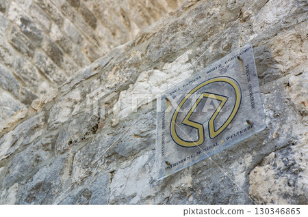 A World Heritage Site sign on a rock wall in the town of Kotor 130346865
