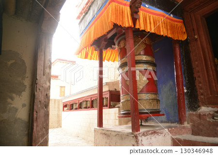 Prayer Wheel at Shey Palace,  A prayer wheel is a cylindrical wheel on a spindle made from metal, wood, stone, leather or coarse cotton. Located at Leh, India. 130346948