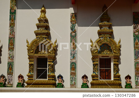 Windows with beautiful Thai art patterns decorate the church at Wat Den Sali Si Mueang Kaen. Located at Chiang Mai Province in Thailand. Windows with beautiful Thai art patterns decorate the church at Wat Den Sali Si Mueang Kaen. Located at Chiang Mai Province in Thailand. 130347286