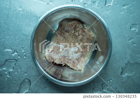 Cat jelly food in a bowl. The savory, gelatinous substance that surrounds the meaty parts of the food, made from the meat stock or broth the food is cooked in. 130348235