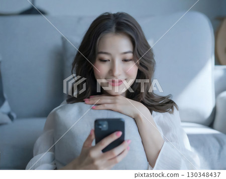 Smiling woman holding a smartphone Generative AI 130348437