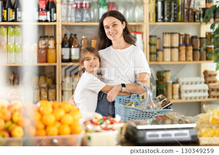 Happy child snuggles up to mother at grocery Happy child snuggles up to mother at grocery 130349259