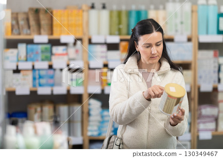 woman chooses baby food in a pharmacy woman chooses baby food in a pharmacy 130349467