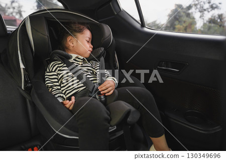 toddler girl sitting and sleeping in car seat, safety baby chair travelling toddler girl sitting and sleeping in car seat, safety baby chair travelling 130349696