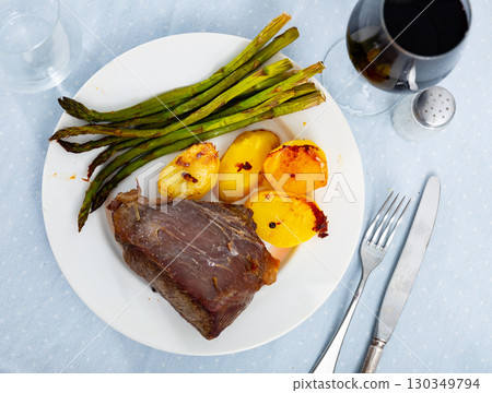 Grilled veal served with potato and asparagus Grilled veal served with potato and asparagus 130349794