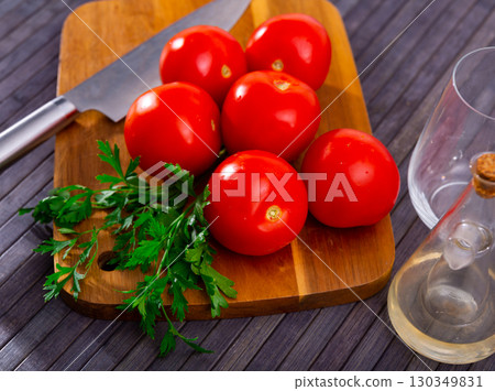 Red tomatoes on kitchen table Red tomatoes on kitchen table 130349831