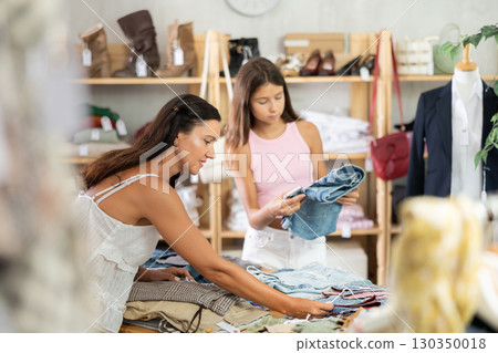 Family customer choose denim jeans or shorts in store 130350018