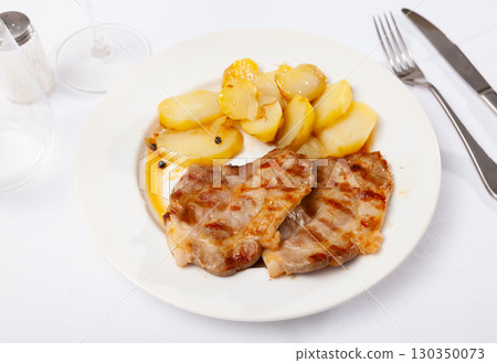 Appetising pork chop served with potato 130350073