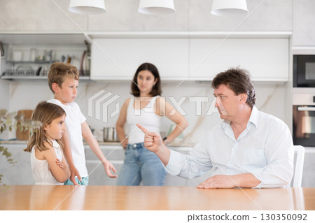 Parents scold their children in kitchen at home 130350092