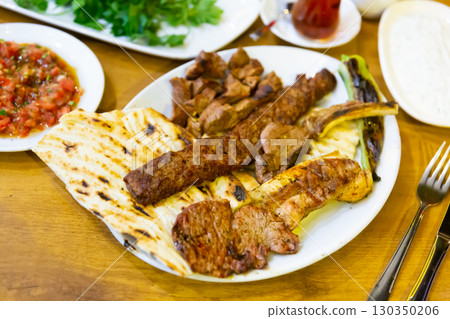 Roasted red meat served on plate with flatbread 130350206