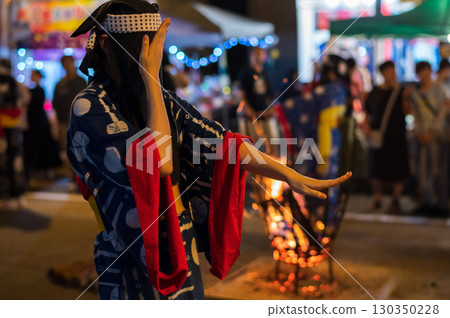 Young women dancing in indigo-dyed yukatas with Hikozono hoods at the Nishimonai Bon Odori Festival 2025 in Akita Prefecture 130350228