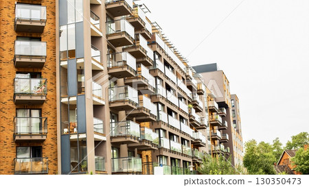 Modern apartment building with balconies and glass facades. Modern apartment building with balconies and glass facades. 130350473