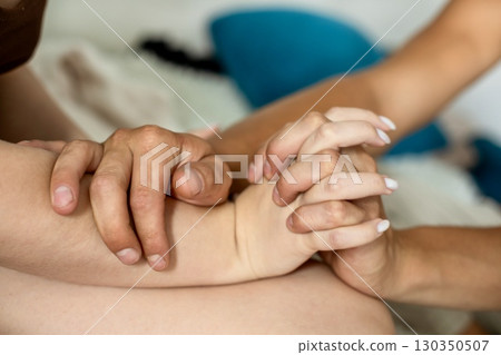Close of a man gently holding a woman hands with care and support, symbolizing love, tenderness Close of a man gently holding a woman hands with care and support, symbolizing love, tenderness 130350507
